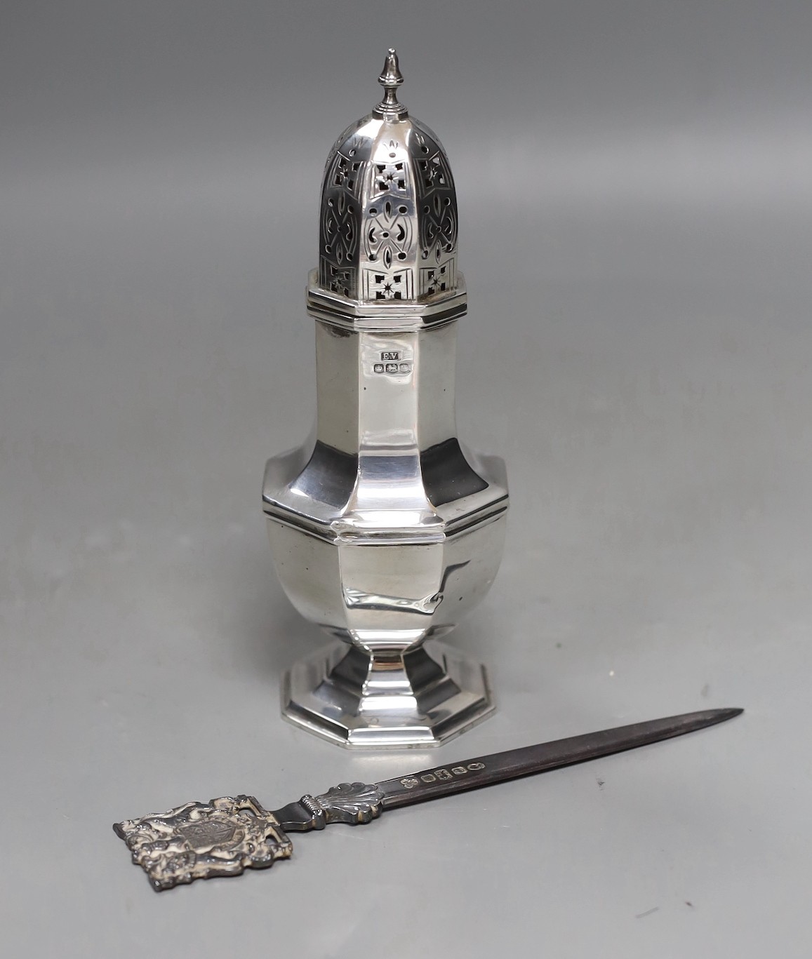 A George V silver octagonal silver sugar caster, Viners Ltd, Sheffield, 1933, 17.8cm and a Royal Jubilee 1977 commemorative letter opener, 17.1cm, 7.2oz.